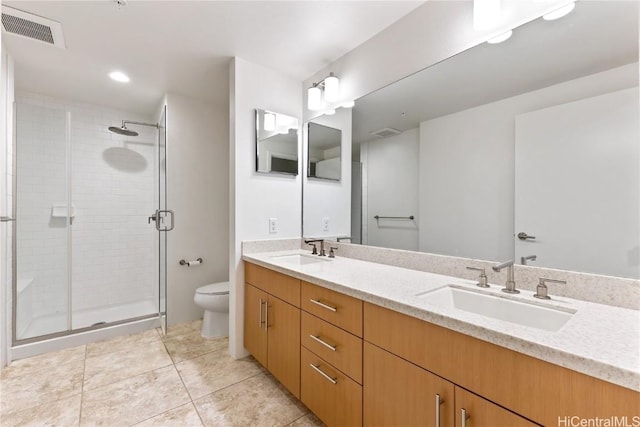 bathroom with tile patterned floors, vanity, an enclosed shower, and toilet