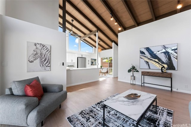 living room featuring high vaulted ceiling, wooden ceiling, wood-type flooring, and beamed ceiling