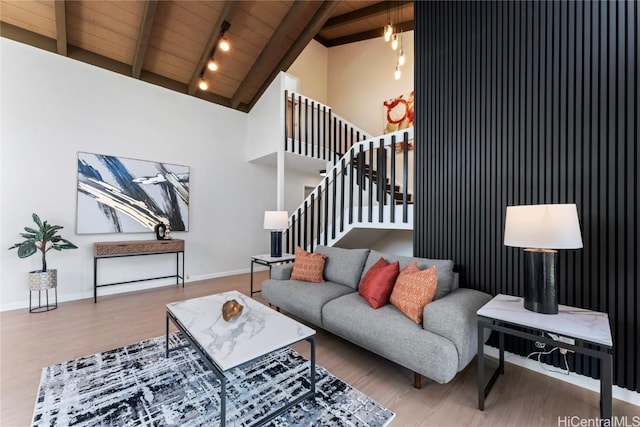 living room with vaulted ceiling with beams, wood ceiling, and hardwood / wood-style flooring