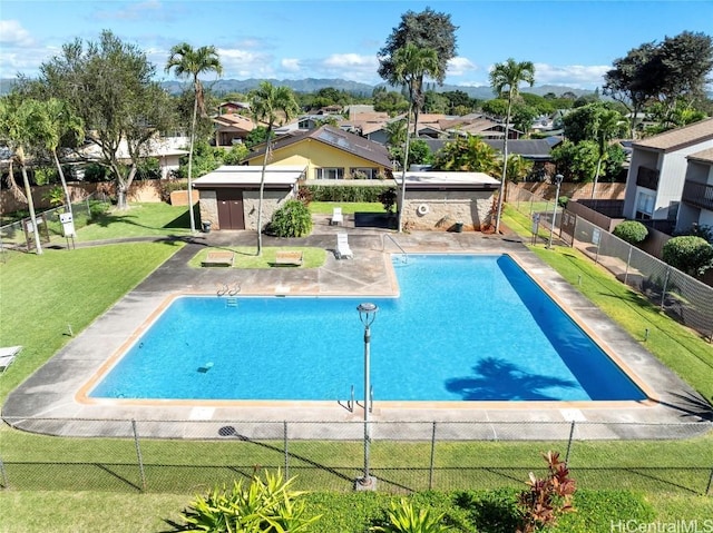 view of pool with a patio area, a lawn, and an outdoor structure