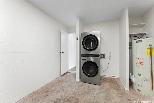 laundry room with stacked washer and dryer and electric water heater