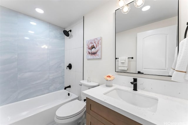 full bathroom with tiled shower / bath combo, vanity, and toilet