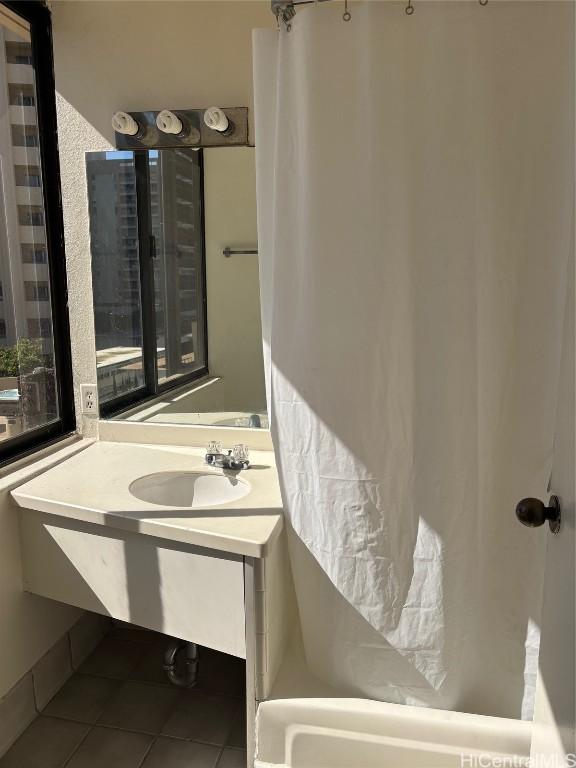 bathroom with vanity, tile patterned floors, and shower / bathtub combination with curtain