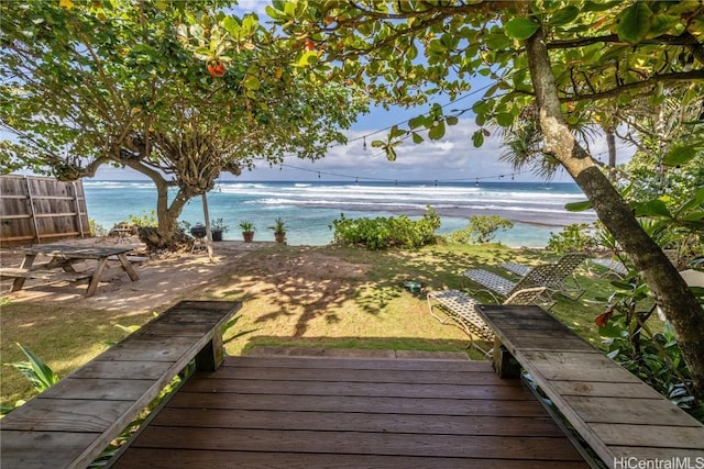 deck featuring a beach view and a water view