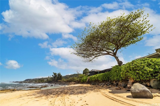 view of road with a water view and a beach view