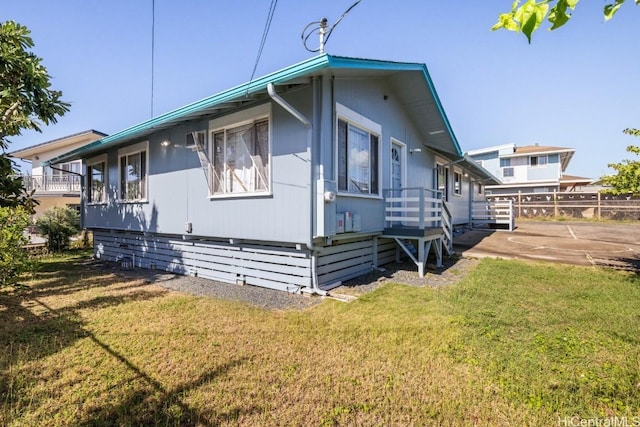 view of side of property with a lawn and a patio