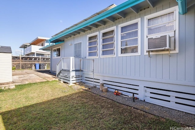 view of side of home with a lawn and a patio