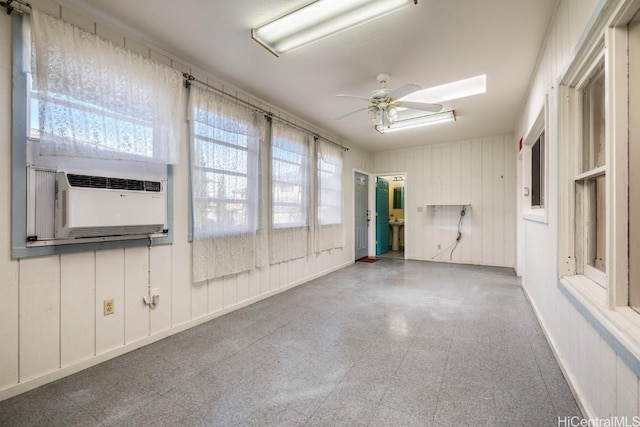 spare room featuring ceiling fan and cooling unit