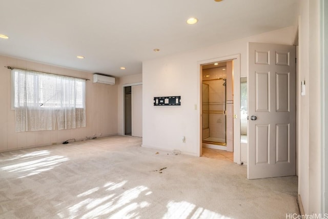 carpeted spare room with a wall mounted AC