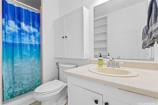 bathroom featuring toilet, vanity, and walk in shower