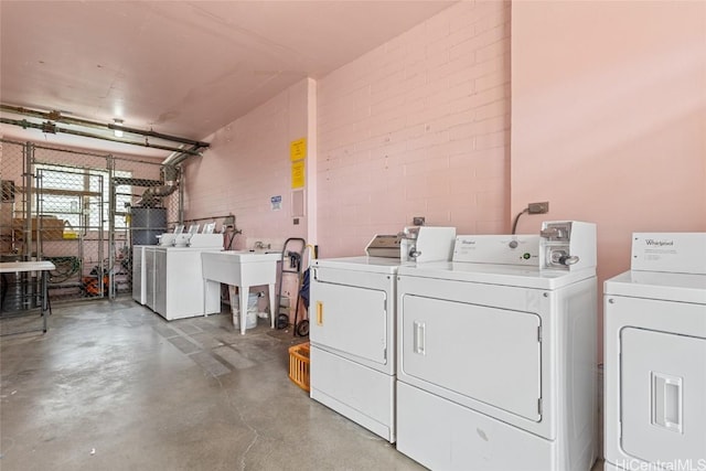 clothes washing area with washer and dryer