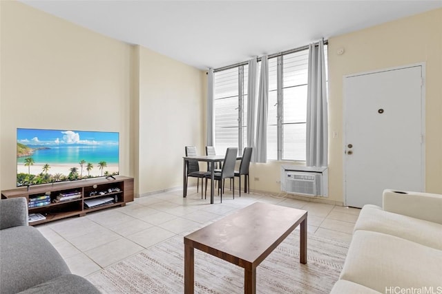 tiled living room featuring an AC wall unit