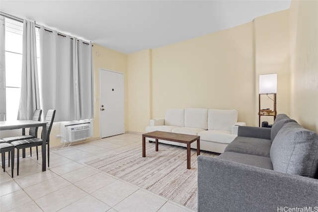 tiled living room featuring a healthy amount of sunlight and a wall unit AC