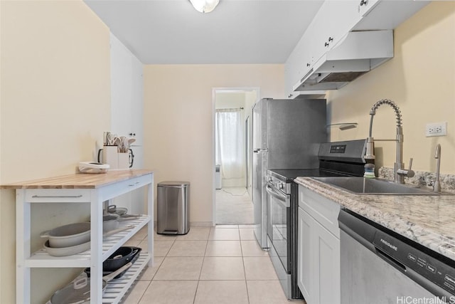 kitchen with sink, white cabinetry, stainless steel appliances, and light tile patterned flooring