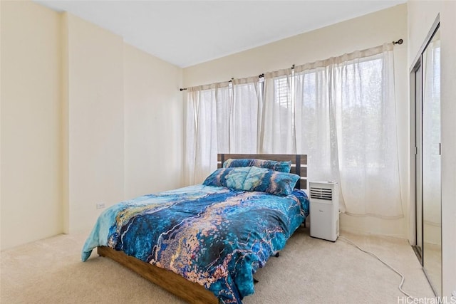 bedroom featuring light colored carpet