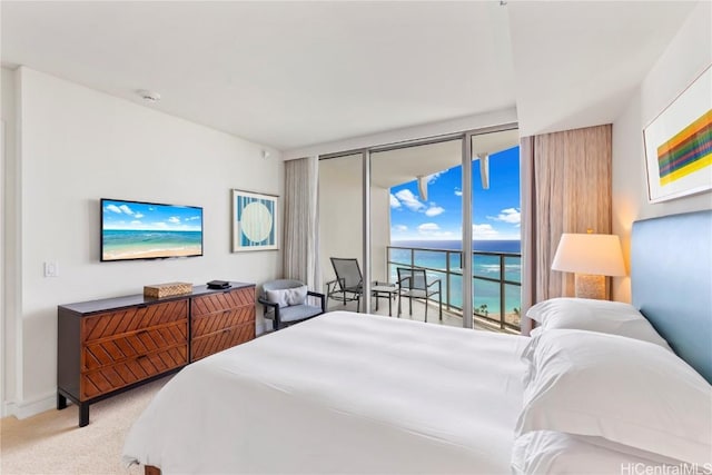 bedroom featuring floor to ceiling windows, light colored carpet, and access to outside