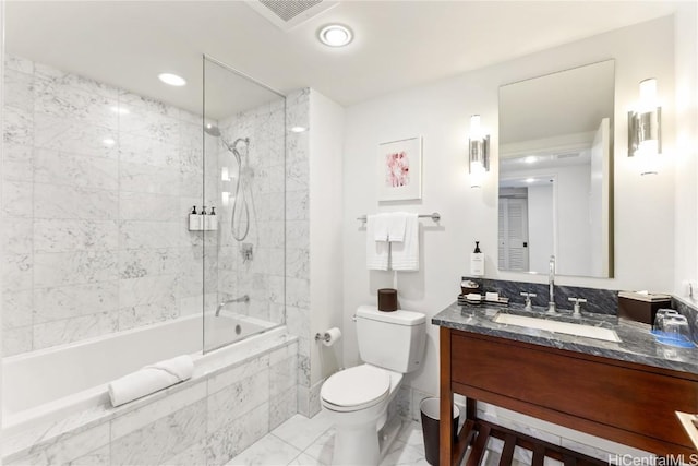 full bathroom with toilet, vanity, and tiled shower / bath