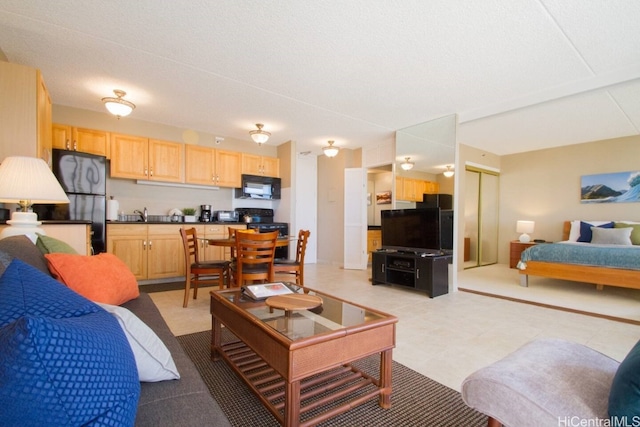 bedroom featuring freestanding refrigerator