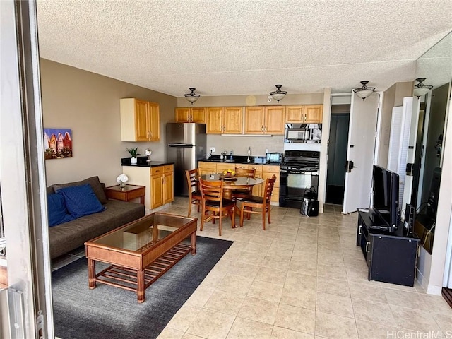 living area featuring light tile patterned floors and a textured ceiling