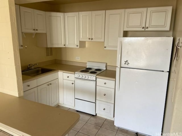 kitchen featuring white cabinetry, sink, light tile patterned floors, and white appliances