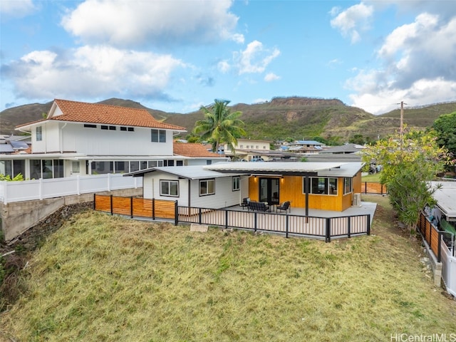 back of property featuring a lawn and a mountain view