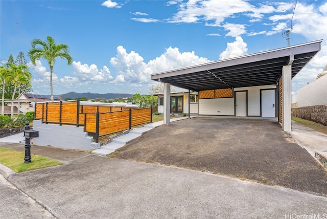 view of parking featuring a mountain view and a carport