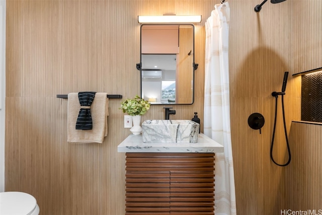 bathroom with a wall mounted air conditioner, vanity, curtained shower, and toilet