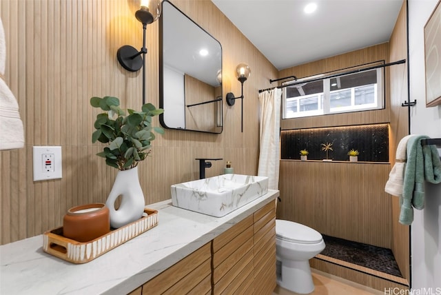 bathroom featuring vanity, toilet, and walk in shower