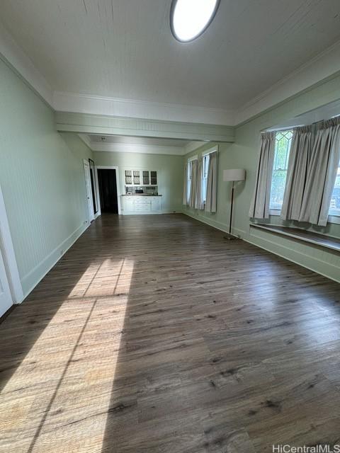 interior space featuring dark hardwood / wood-style floors and ornamental molding