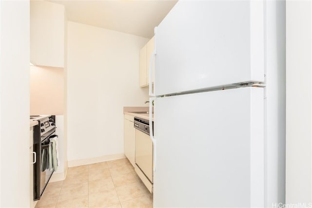 kitchen featuring light tile patterned floors, white appliances, and white cabinetry