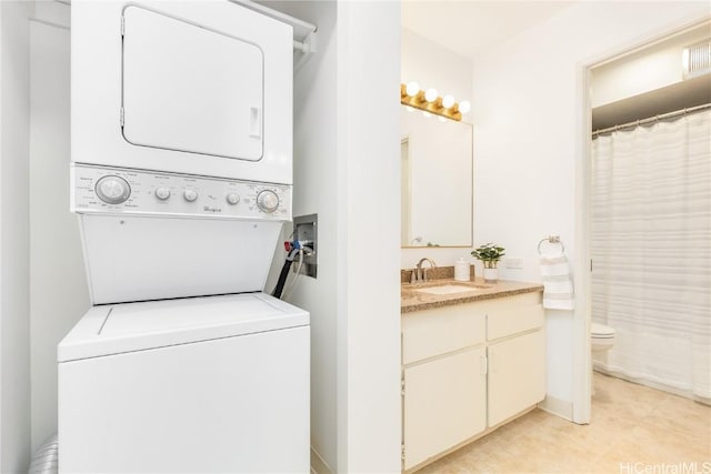 clothes washing area featuring light tile patterned flooring, stacked washer / dryer, and sink