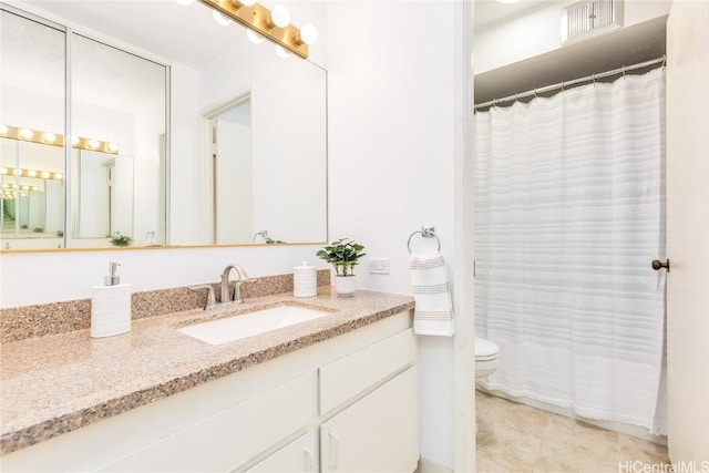 bathroom featuring tile patterned floors, vanity, a shower with shower curtain, and toilet