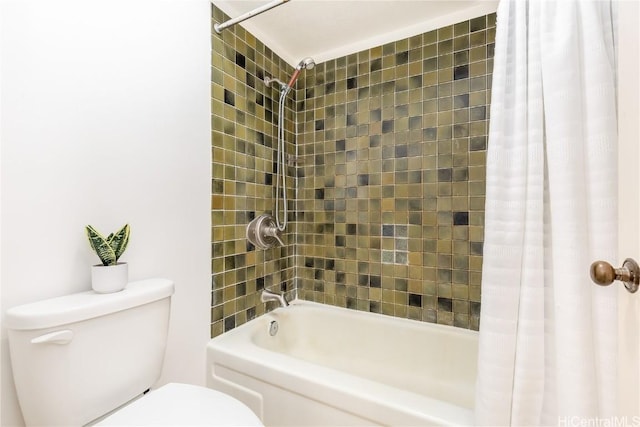 bathroom featuring shower / bath combination with curtain and toilet