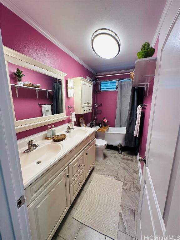 full bathroom featuring crown molding, shower / tub combo with curtain, vanity, and toilet