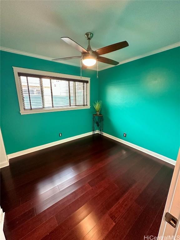 spare room with hardwood / wood-style flooring, ornamental molding, and ceiling fan