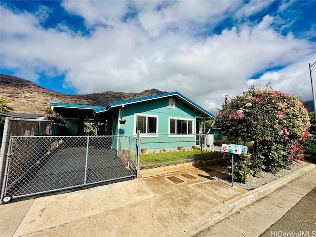 view of front of house with a carport and a mountain view