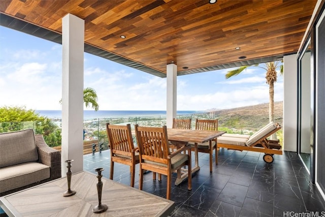 exterior space featuring a water view and a view of the beach