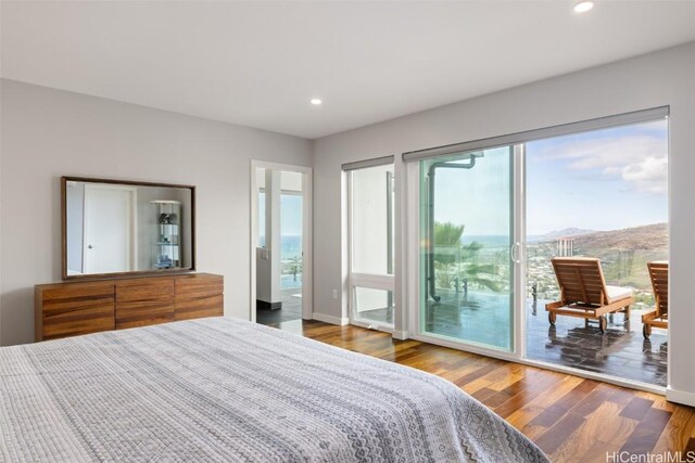 bedroom with wood-type flooring and access to outside