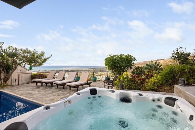 view of pool featuring a patio and a hot tub