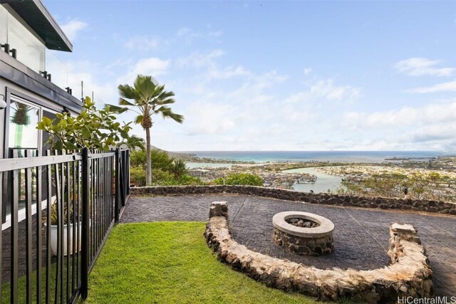 view of yard featuring a fire pit and a water view