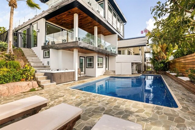 rear view of house with a balcony and a patio