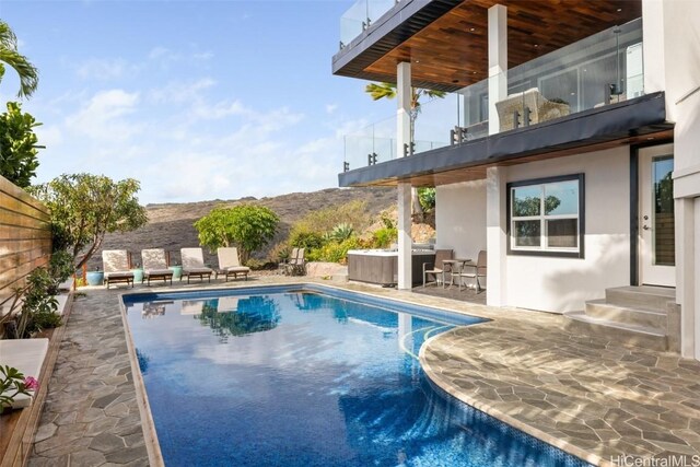 view of swimming pool with a mountain view and a patio