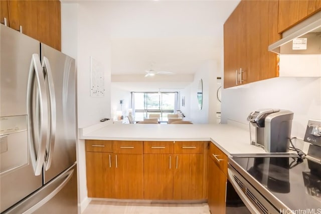 kitchen with ceiling fan, kitchen peninsula, stainless steel appliances, and extractor fan