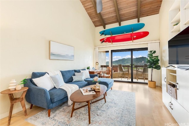 living room featuring beamed ceiling, light wood-type flooring, high vaulted ceiling, and wood ceiling