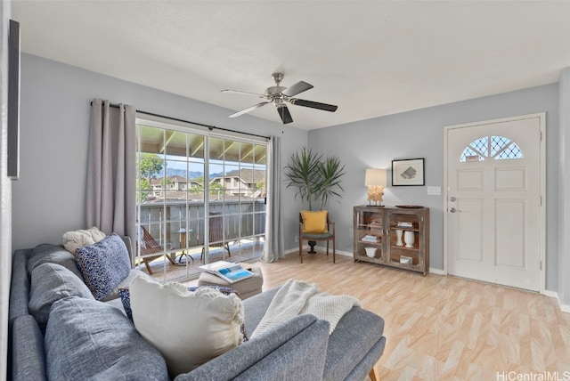 living room featuring light hardwood / wood-style flooring, ceiling fan, and a water view