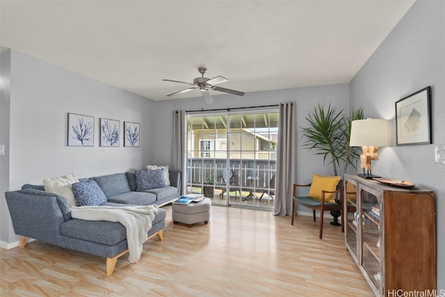 living room with ceiling fan and light hardwood / wood-style flooring