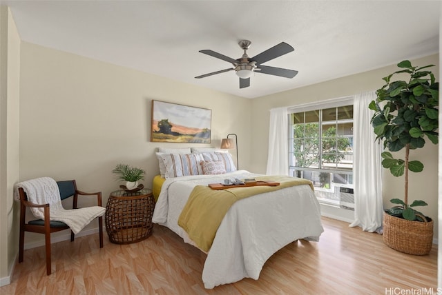 bedroom with ceiling fan and light wood-type flooring