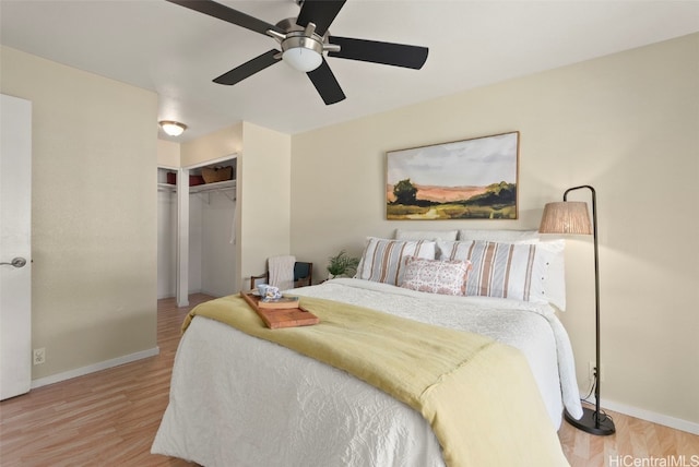 bedroom with ceiling fan, light hardwood / wood-style floors, and a closet