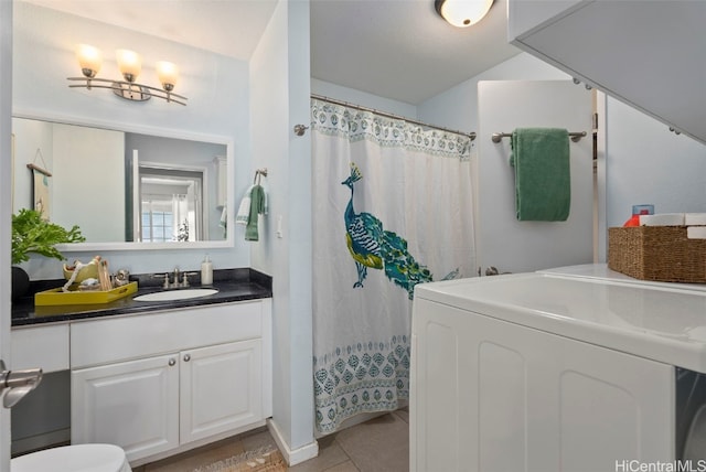 bathroom with vanity, washer / clothes dryer, and tile patterned flooring