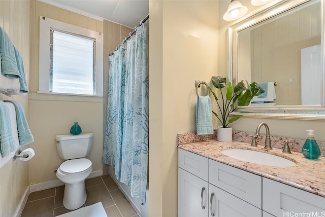 bathroom with vanity, tile patterned floors, toilet, ornamental molding, and curtained shower